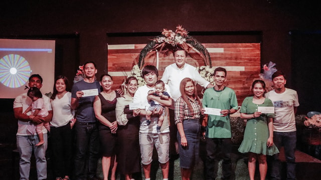 The MCOF church family celebrating together on stage