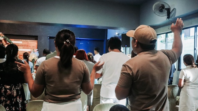 Members worshipping together during a Sunday service